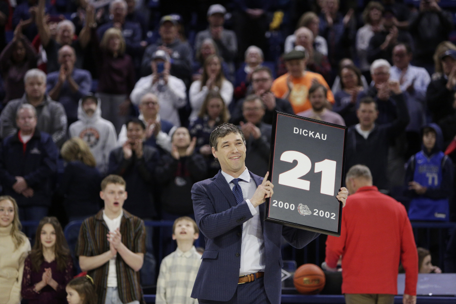 Former Gonzaga and NBA basketball player Dan Dickau holds a framed Gonzaga jersey number during his jersey retirement ceremony before an NCAA college basketball game between Gonzaga and San Francisco, Thursday, Feb. 9, 2023, in Spokane, Wash.