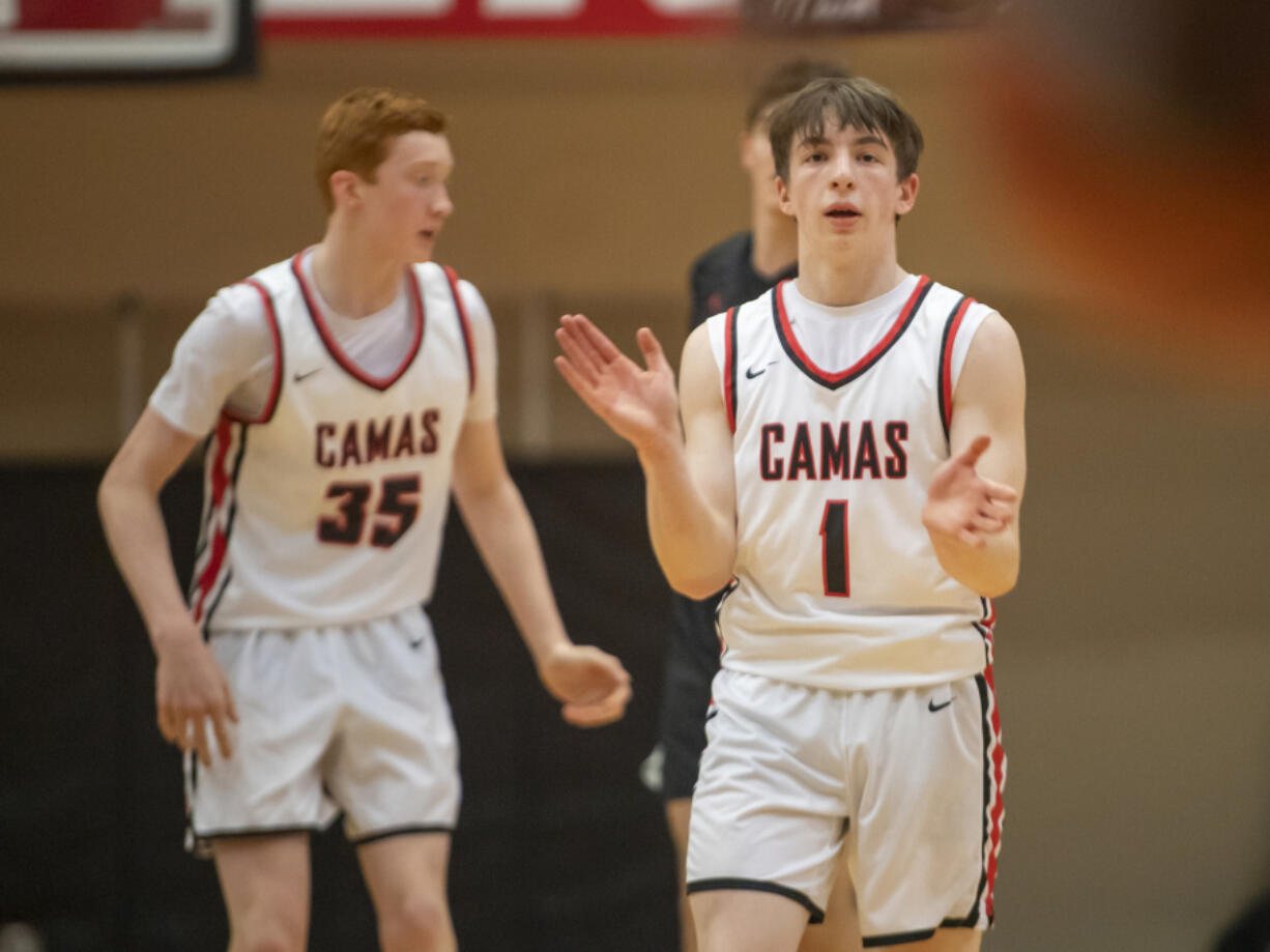 Beckett Currie (1), Ethan Harris (35) and Camas boys basketball are one of three local teams to have clinched berths in the regional round of the state tournament.