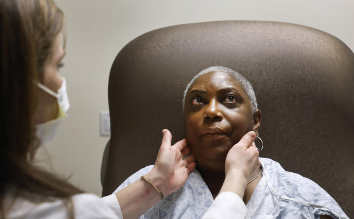 Nurse practitioner Rachel Roberts examines Stephanie Walker of Tarboro, N.C., during an appointment Feb. 2 at the Duke Cancer Clinic in Durham, N.C. For the last six years, Walker has endured painful monthly injections to help treat her cancer.