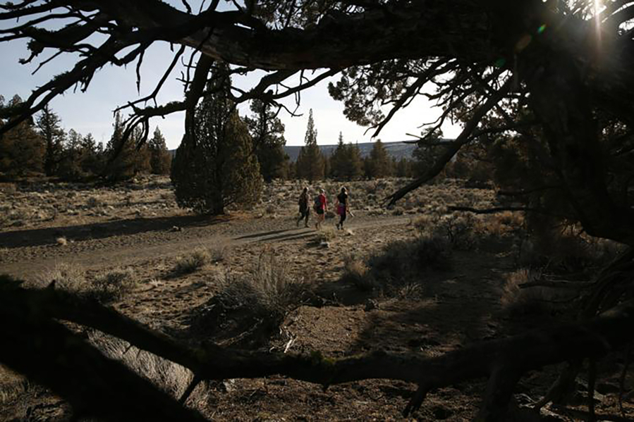Hikers walk through the Badlands east of Bend, Ore.