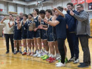 King’s Way Christian poses for photos with the 1A District 4 Championship trophy after defeating Elma on Saturday, Feb. 18, 2023, at Castle Rock High School.