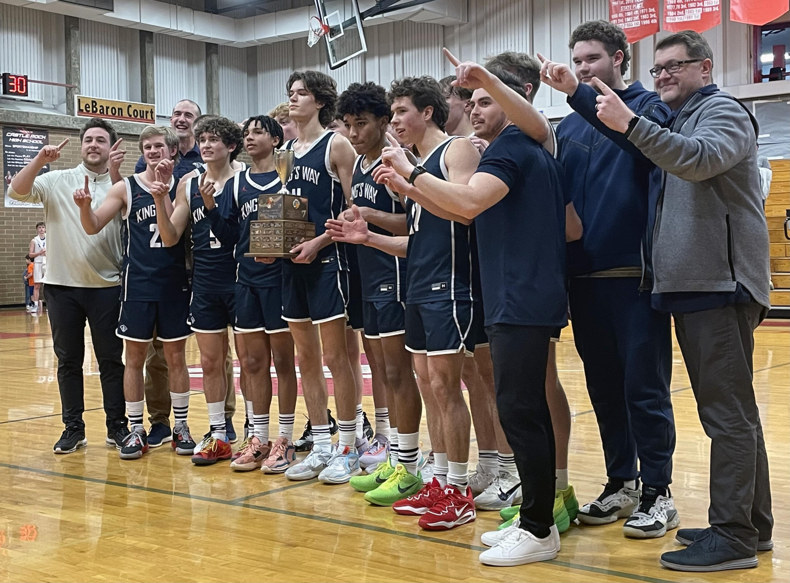 King’s Way Christian poses for photos with the 1A District 4 Championship trophy after defeating Elma on Saturday, Feb. 18, 2023, at Castle Rock High School.