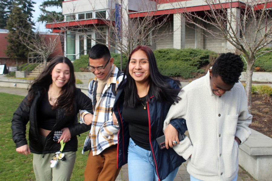 From left, Keiley Pyeatt, Philip Palpita, Margarita Sanchez, and Branton Waitiki, all age 17 and students in the Running Start program at Tacoma Community College, walk arm-in-arm in front of the student center.