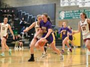 Columbia River's Gracie Glavin (33) pushes the ball up the court while being closely guarded by Enumclaw's Natalie DeMarco in a Class 2A state opening round game on Saturday, Feb. 25, 2023, at Auburn High School.