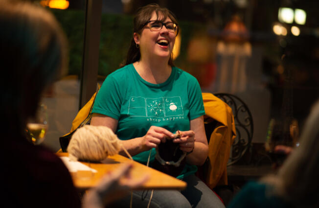 Jen Langdon laughs and knits while drinking riesling at Niche Wine Bar in downtown Vancouver. Bars are offering activities not usually associated with drinking establishments to lure customers, especially midweek.