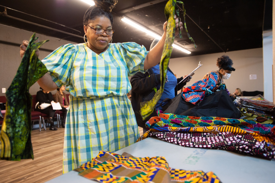 Designer Dora Darlington sorts through samples of clothing from her native Ghana at a fitting in advance of Saturday's Black History Month Fashion Show at The Lord's Gym in Vancouver.