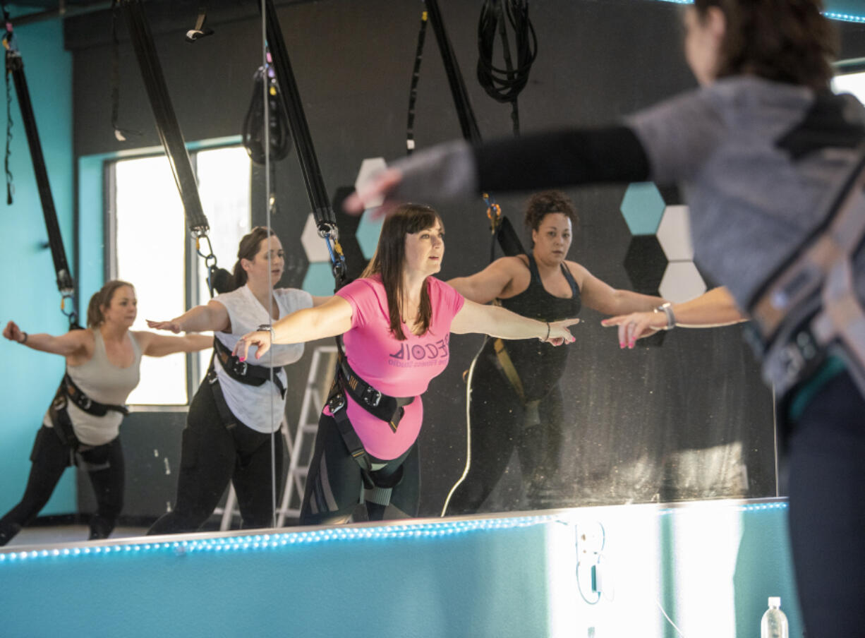 Owner and instructor Krista Davis, center, leads exercise classes at Recoil Bungee Fitness in Vancouver.