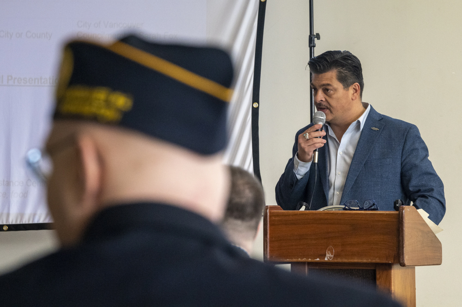 Governor's Veterans Affairs Advisory Committee member Paul Herrera speaks to a crowd Wednesday during a veterans services town hall at the Armed Forces Reserve Center in Vancouver.