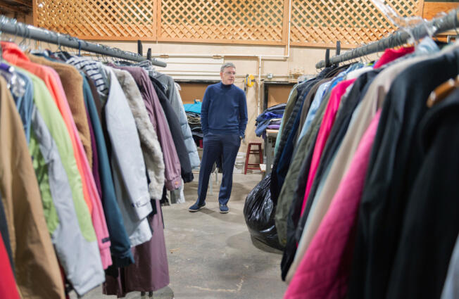 Tod Thayer, Friends of the Carpenter executive director, stands among donated coats at the organization's annual coat giveaway Tuesday, organized in partnership with the Boy Scouts of America. Thayer invited various nonprofit organizations to pick up coats to distribute to homeless and low-income clients.