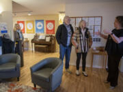 Kate Sacamano of Friends of the Children Southwest Washington, from left, looks on as philanthropists Gary and Christine Rood talk with Allison Pauletto during a tour of the clubhouse. The Roods recently donated $33 million to the national organization, $5 million of which will go toward building a new clubhouse for the Southwest Washington chapter.