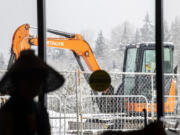 An excavator sits outside the windows of ilani on Tuesday during a ground-breaking ceremony for its Meeting & Entertainment Center expansion.