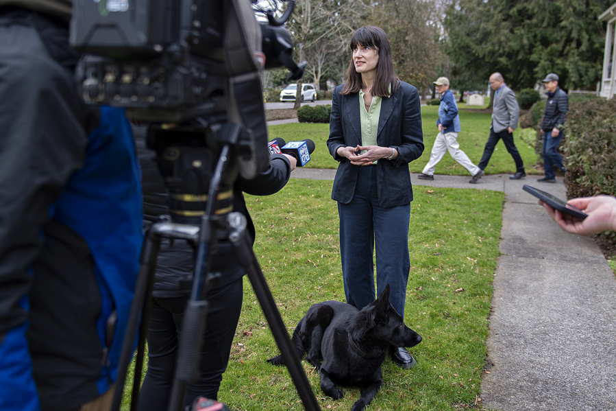 Rep. Marie Gluesenkamp Perez, D-Skamania, answers questions from the media with her German shepherd, Uma Furman, at the grand opening of her district office on Officers Row in Vancouver. Perez emphasized Thursday that her staff is always available for questions about VA benefits, small-business aid and other federal programs.