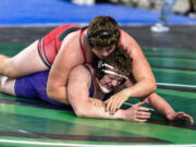 Yelm’s Jonah Smith, 285 pounds, competes against Heritage’s Austin Steinbach in the semifinals at Mat Classic XXXIV on Saturday, February 18, 2023, at the Tacoma Dome.