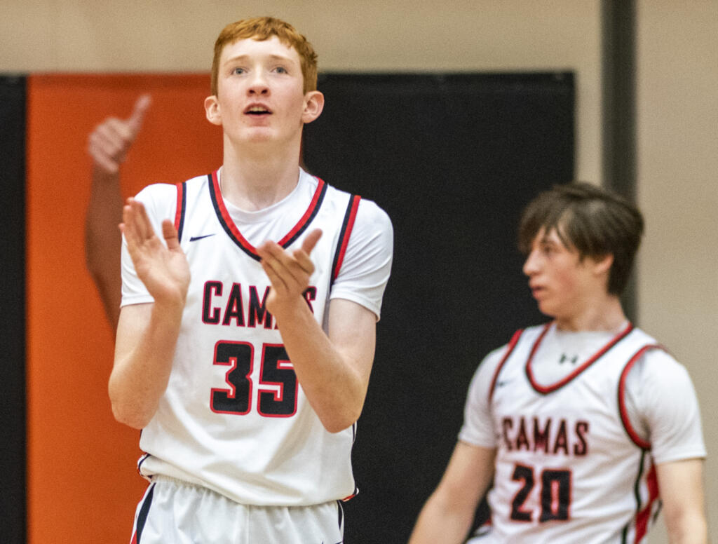 Camas freshman Ethan Harris, left, celebrates after a call Friday, Feb. 24, 2023, during the Papermakers’ 64-53 win against West Valley - Yakima at Battle Ground High School.