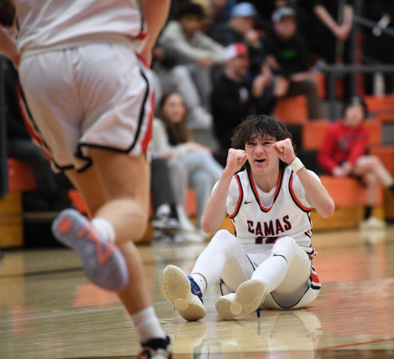 Camas sophomore Jace VanVoorhis, right, celebrates after winning a turnover Friday, Feb. 24, 2023, during the Papermakers’ 64-53 win against West Valley - Yakima at Battle Ground High School.