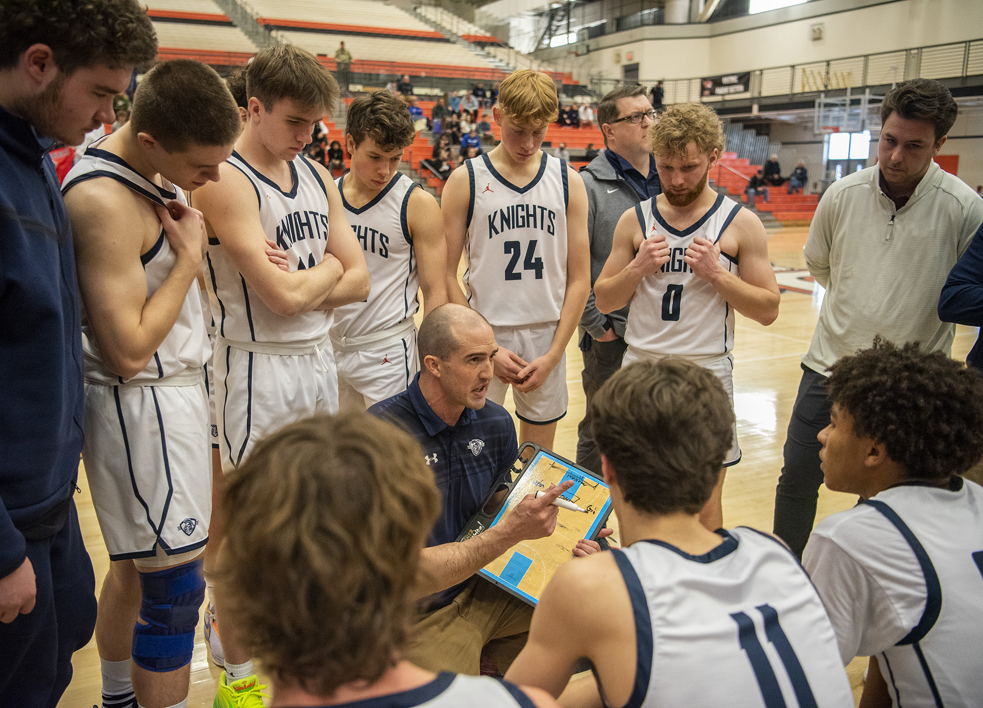 King's Way head boys basketball coach Daven Harmeling, center, talks to the team between quarters Saturday, Feb. 25, 2023, during the Knights’ 59-44 win against La Salle at Battle Ground High School.