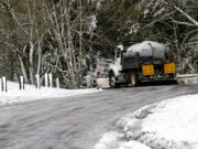 A snowplow travels Northeast Leverich Park Way in Vancouver late Thursday morning, Feb. 23, 2023.