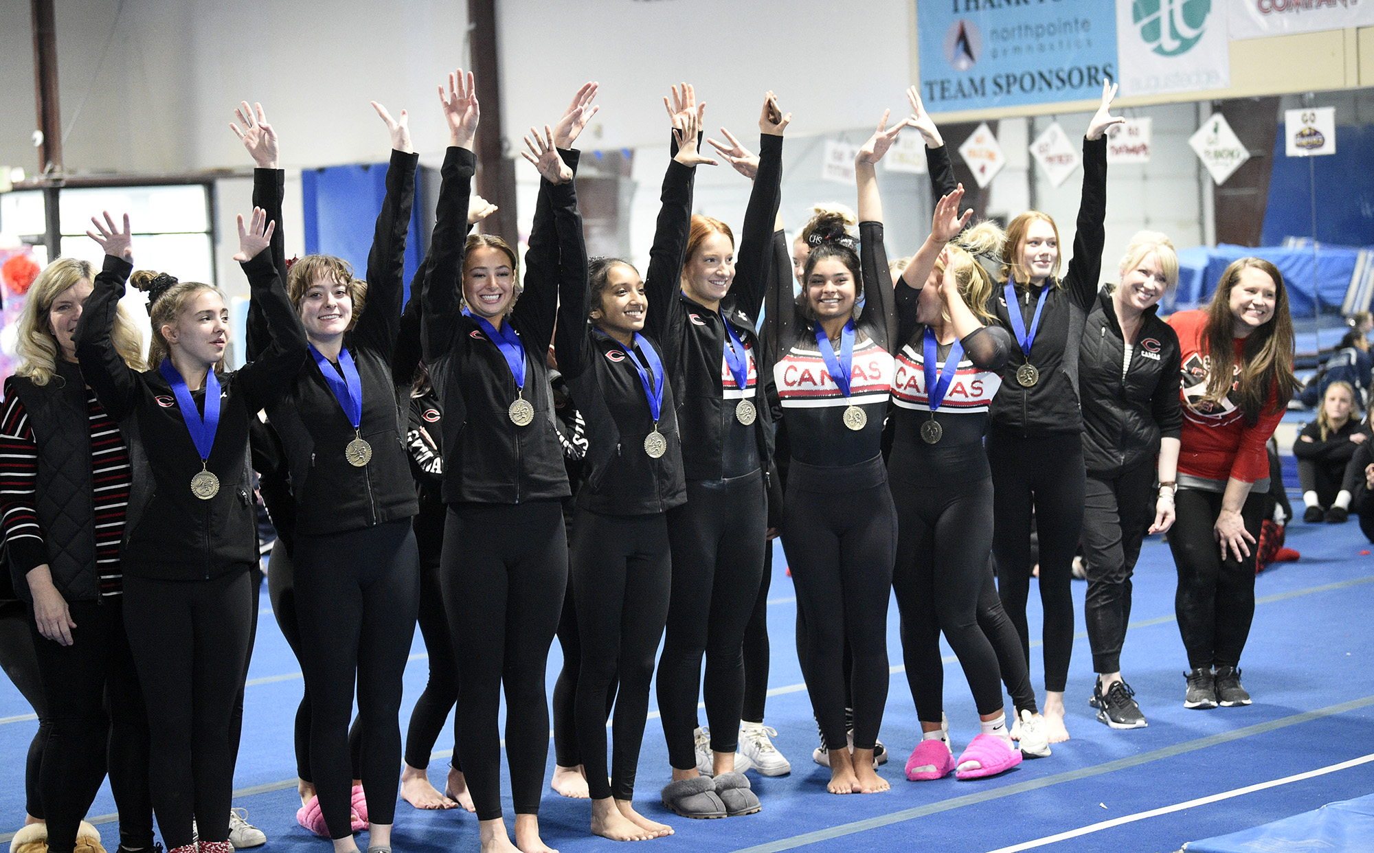 The Camas gymnastics team celebrates its team title at the 4A District 4 meet at Northpointe on Saturday, Feb. 11, 2023.