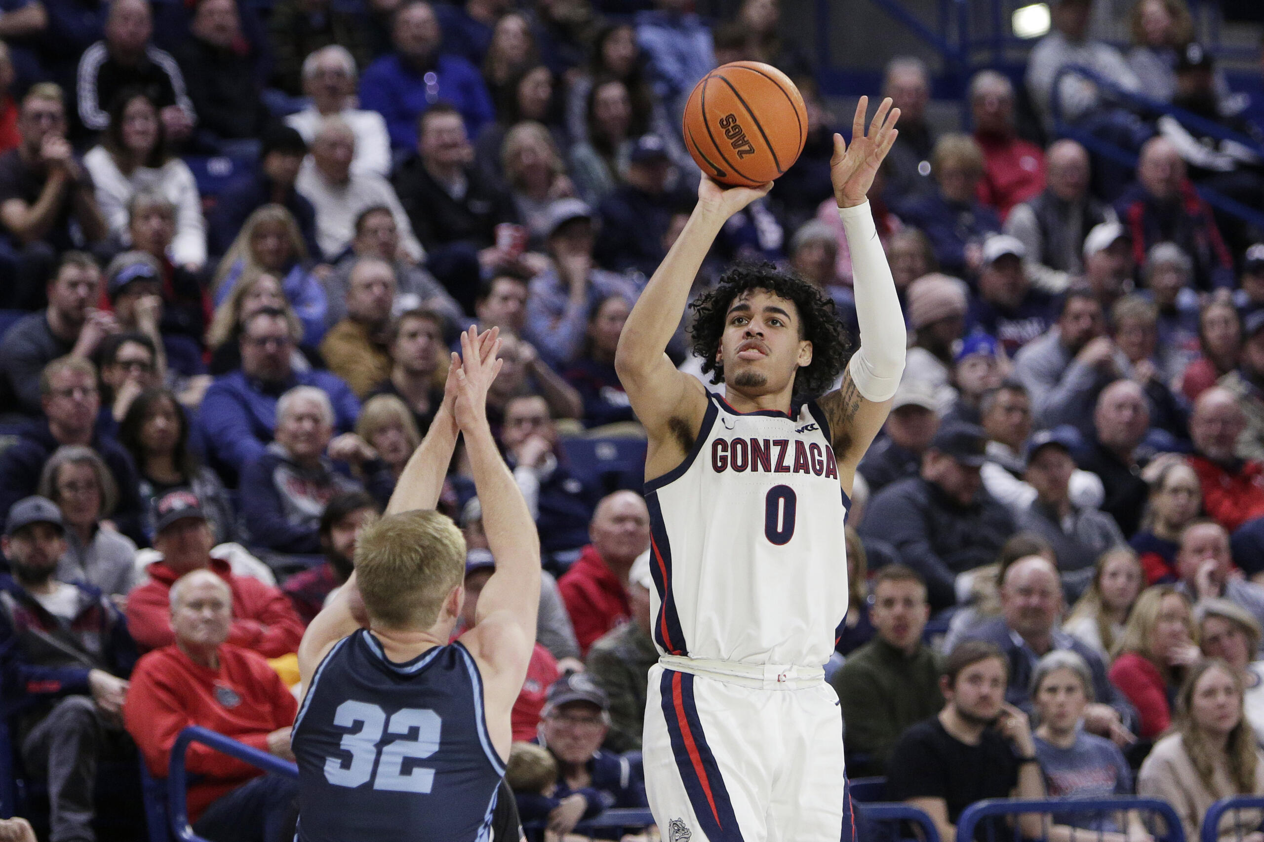 Gonzaga guard Julian Strawther (0) shoots while defended by San Diego guard Dominic Muncey (32) during the second half of an NCAA college basketball game Thursday, Feb. 23, 2023, in Spokane, Wash. Gonzaga won 97-72.