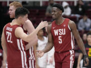 Washington State guard Dylan Darling (22) celebrates with guard TJ Bamba (5) and guard Jabe Mullins after the team defeated Stanford in an NCAA college basketball game in Stanford, Calif., Thursday, Feb. 23, 2023.