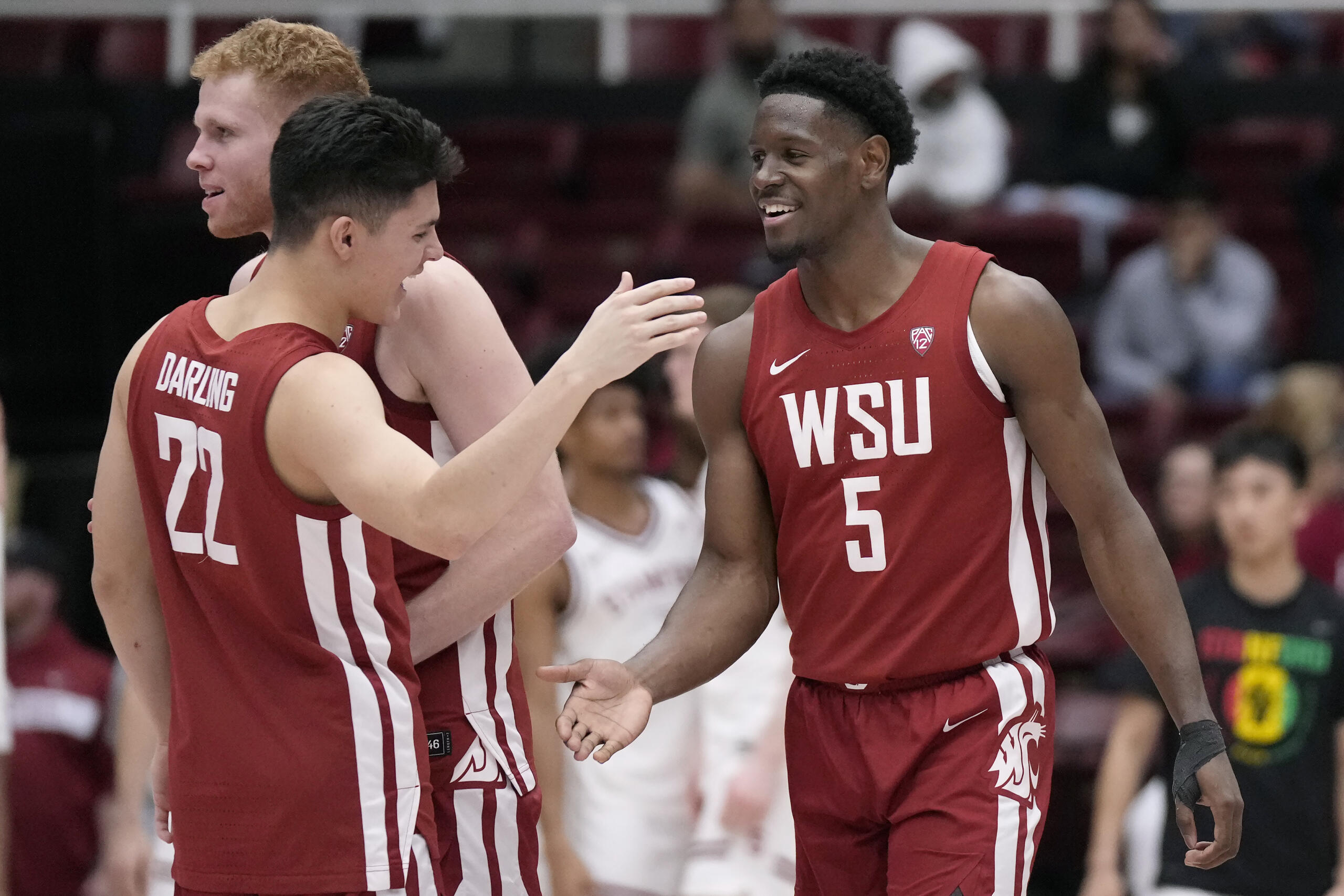 Washington State guard Dylan Darling (22) celebrates with guard TJ Bamba (5) and guard Jabe Mullins after the team defeated Stanford in an NCAA college basketball game in Stanford, Calif., Thursday, Feb. 23, 2023.