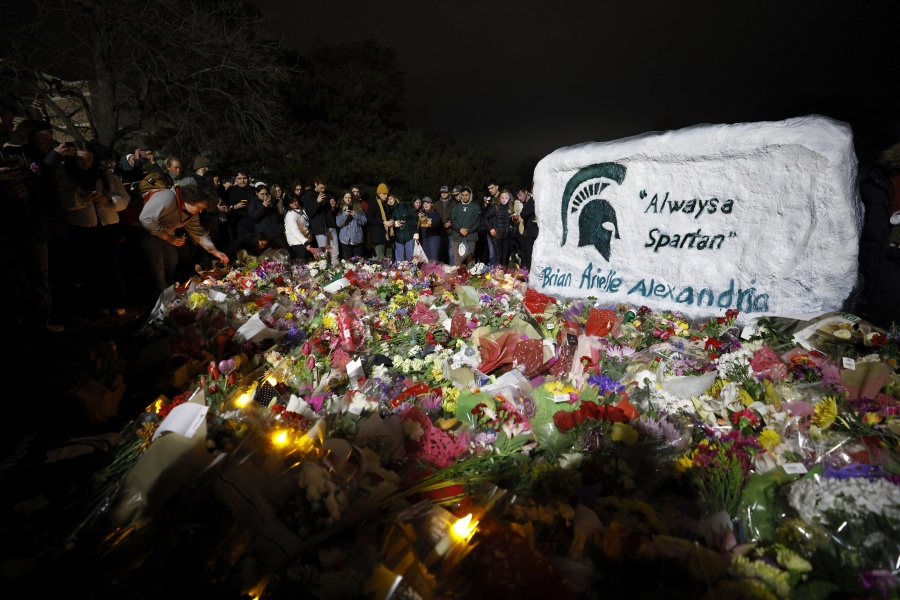 Mourners attend a vigil at The Rock on the grounds of Michigan State University in East Lansing, Mich., Wednesday, Feb. 15, 2023. Alexandria Verner, Brian Fraser and Arielle Anderson were killed and several other students remain in critical condition after a gunman opened fire on the campus of Michigan State University Monday night.