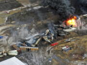 This photo taken with a drone shows portions of a Norfolk and Southern freight train that derailed Friday night in East Palestine, Ohio are still on fire at mid-day Saturday, Feb. 4, 2023. (AP Photo/Gene J.