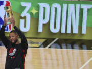 Damian Lillard of the Portland Trail Blazers celebrates after winning the three-point contest at the NBA basketball All-Star weekend Saturday, Feb. 18, 2023, in Salt Lake City.