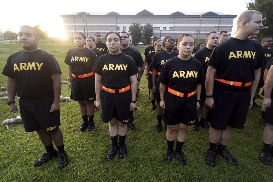 FILE - Students in the new Army prep course stand at attention after physical training exercises at Fort Jackson in Columbia, S.C., Aug. 27, 2022. The Army is trying to recover from its worst recruiting year in decades, and officials say those recruiting woes are based on traditional hurdles. The Army is offering new programs, advertising and enticements to try to change those views and reverse the decline.
