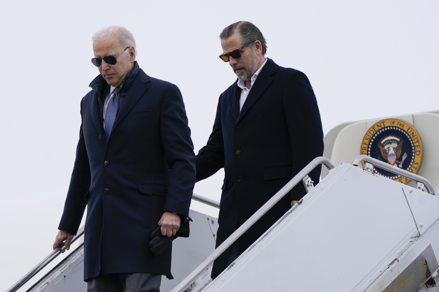 President Joe Biden and his son, Hunter Biden, step off Air Force One, Saturday, Feb. 4, 2023, at Hancock Field Air National Guard Base in Syracuse, N.Y. The Bidens are in Syracuse to visit with family members following the passing of Michael Hunter, the brother of the president's first wife, Neilia Hunter Biden.