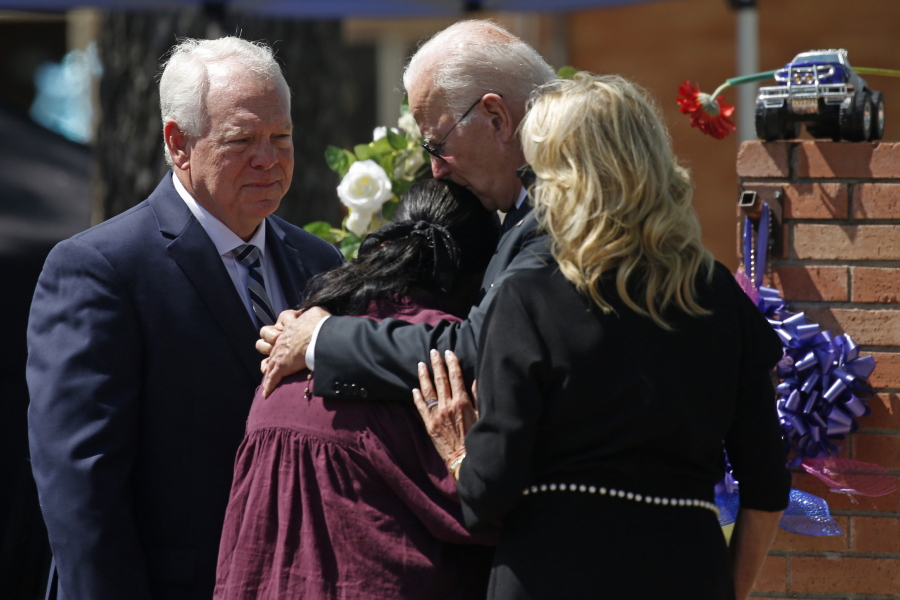FILE - President Joe Biden and first lady Jill Biden comfort Principal Mandy Gutierrez as Superintendent Hal Harrell stands next to them, at a memorial outside Robb Elementary School to honor the victims killed in a school shooting in Uvalde, Texas, May 29, 2022.