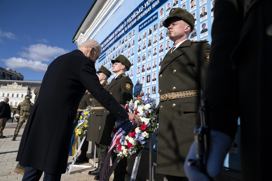 US President Joe Biden participates in a wreath laying ceremony with Ukrainian President Volodymyr Zelenskyy at the memorial wall outside of St. Michael's Golden-Domed Cathedral during an unannounced visit, in Kyiv, Ukraine, Monday, Feb. 20, 2023.