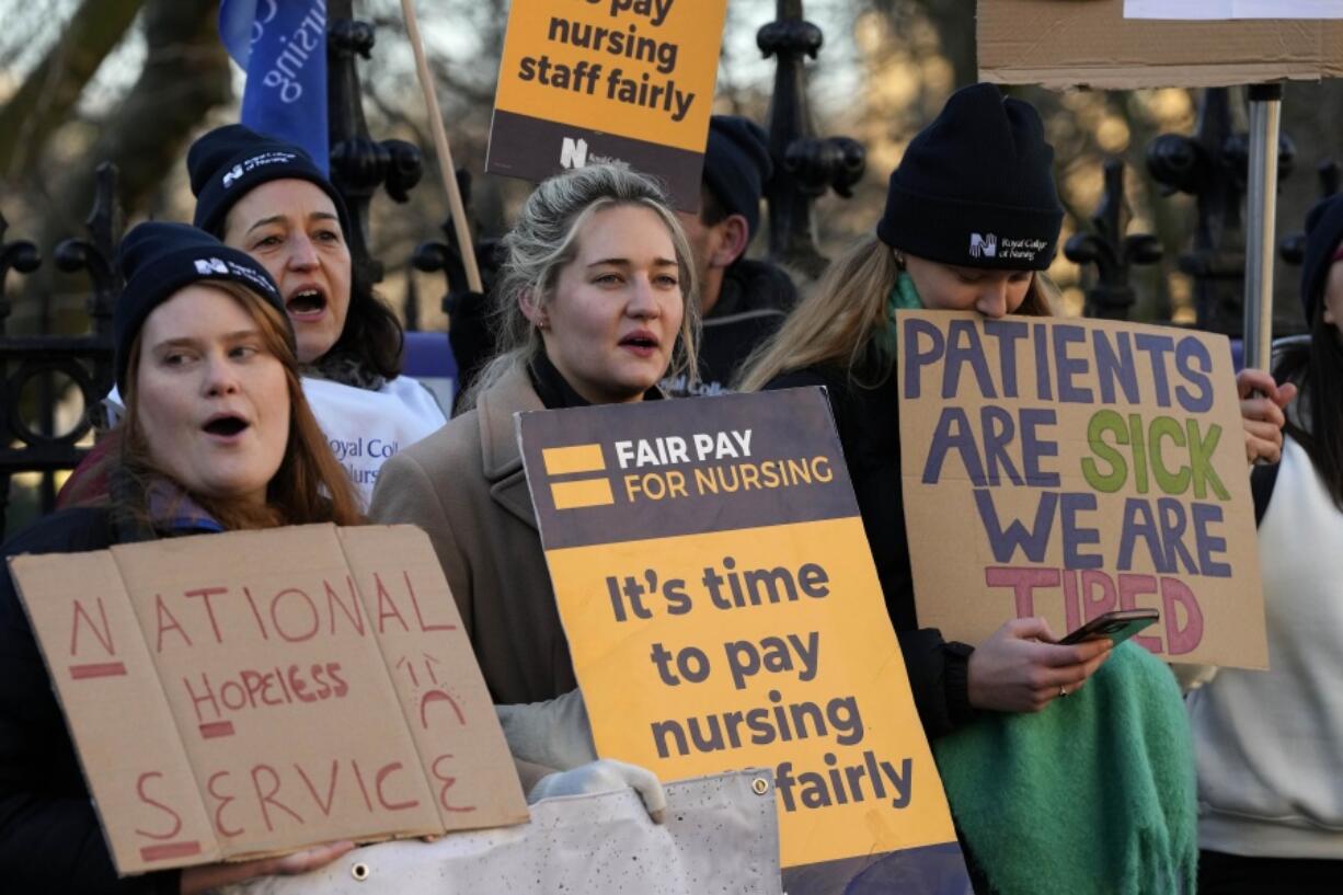 Nurses of the nearby St. Thomas' Hospital stand on the picket line, in London, Monday, Feb. 6, 2023. Tens of thousands of nurses and ambulance staff walked off the job in the U.K. Monday in what unions called the biggest strike in the history of Britain's public health system.