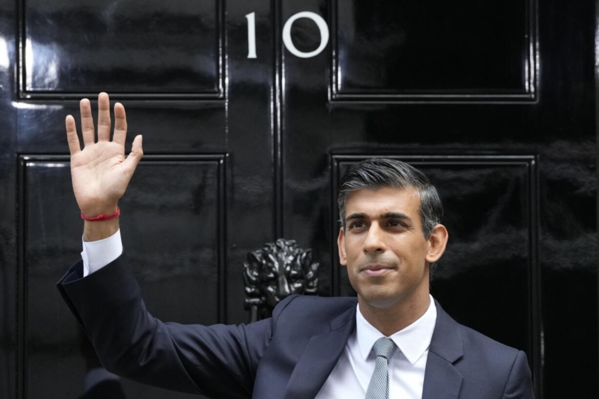FILE - New British Prime Minister Rishi Sunak waves after arriving at Downing Street in London, Tuesday, Oct. 25, 2022, after returning from Buckingham Palace where he was formally appointed to the post by Britain's King Charles III.