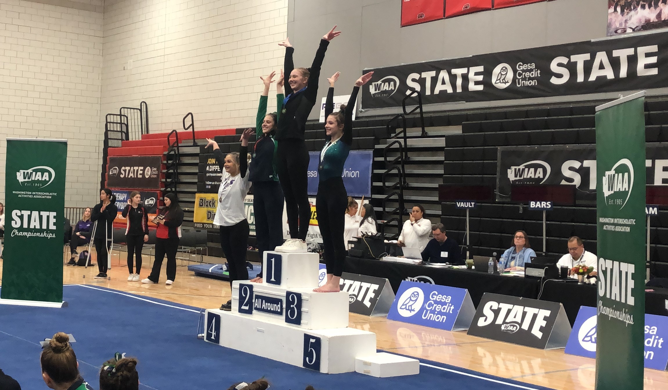 Camas junior Madi Williams stands atop to podium after winning the Class 4A all-around title at the WIAA State Gymnastics Championships on Friday, Feb. 24, 2023 at Sammamish High School in Bellevue.