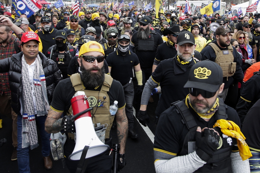 FILE - Proud Boys member Jeremy Joseph Bertino, second from left, joins other supporters of President Donald Trump who are wearing attire associated with the Proud Boys as they attend a rally at Freedom Plaza, Dec. 12, 2020, in Washington. Bertino told jurors on Tuesday, Feb. 21, 2023, that he viewed their far-right extremist organization as "the tip of the spear" after the 2020 election. Bertino is testifying against former Proud Boys national leader Enrique Tarrio and four lieutenants as part of a cooperation deal with federal prosecutors. (AP Photo/Luis M.