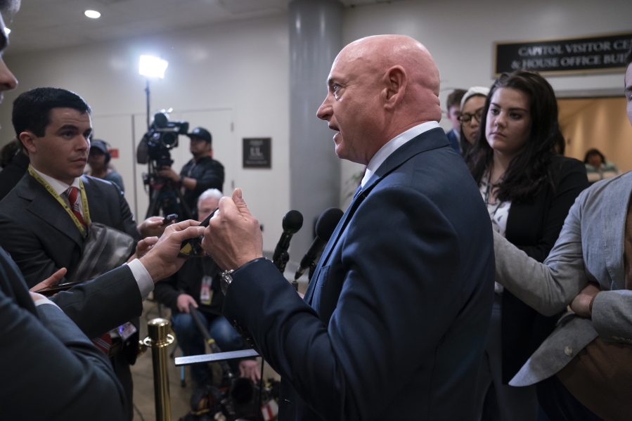 FILE - Sen. Mark Kelly, D-Ariz., speaks with reporters following a classified briefing on China, at the Capitol in Washington, Feb. 15, 2023. Senators are investigating how the suspected Chinese surveillance balloon was allowed to pass over crucial missile sites. Kelly is a former astronaut. He wants to require weather balloons to carry a radar transponder. (AP Photo/J.