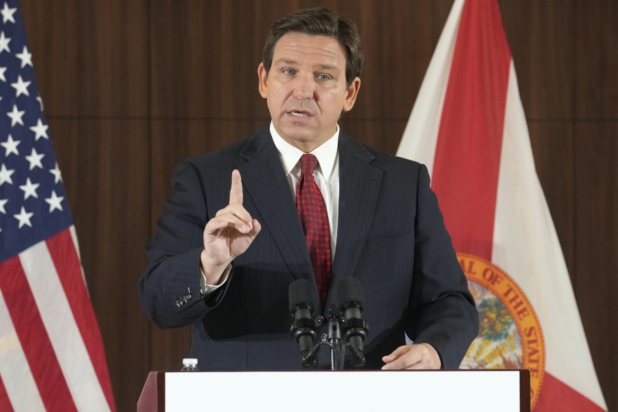 FILE - Florida Gov. Ron DeSantis gestures during a news conference, Thursday, Jan. 26, 2023, in Miami. DeSantis on Tuesday, Jan. 31, 2023, announced plans to block state colleges from having programs on diversity, equity and inclusion, and critical race theory.
