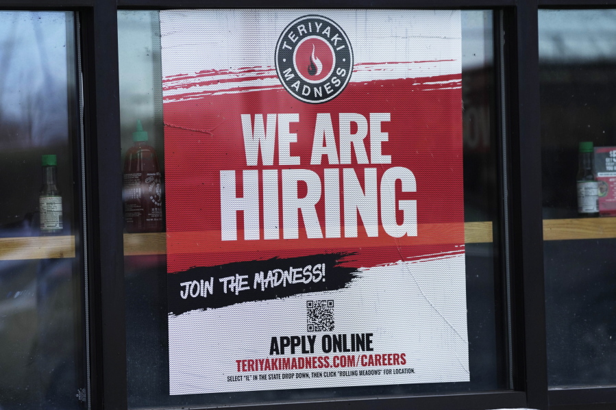 A hiring sign is displayed at a restaurant in Rolling Meadows, Ill., Monday, Jan. 30, 2023. America's employers added a robust 517,000 jobs in January, a surprisingly strong gain in the face of the Federal Reserve's aggressive drive to slow growth and tame inflation with higher interest rates.(AP Photo/Nam Y.