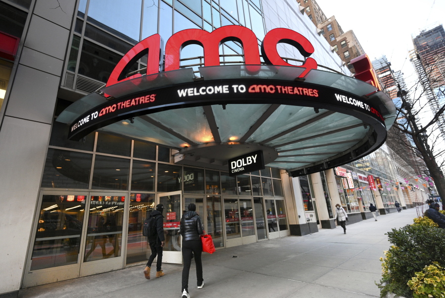 FILE - People walk by the AMC 34th Street theater on March 5, 2021, in New York. AMC Theaters, the nation's largest movie theater chain, on Monday unveiled a new pricing scheme in which seat location determines how much your movie ticket costs. Seats in the middle will cost a dollar or two more, while seats in the front row will be slightly cheaper.