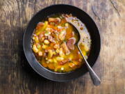 This image released by Milk Street shows a recipe for Spanish Chorizo, Ham and White Bean Stew.