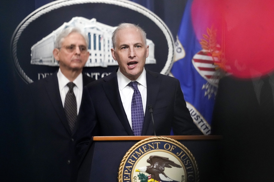 FILE - Justice Department's Assistant Attorney General for the National Security Division Matthew Olsen speaks during a news conference at the Department of Justice in Washington, Jan. 27, 2023, as Attorney General Merrick Garland listens at left. The Biden administration officials urged Congress on Tuesday to renew a surveillance program that the U.S. government has long seen as vital in countering overseas terrorism, cyberattacks and espionage operations.  The program, which is under the Foreign Intelligence Surveillance Act, or FISA, is set to expire at year's end unless Congress agrees to renew it.