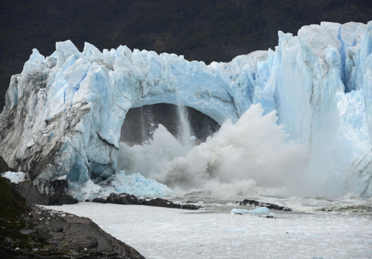 FILE - Chunks of ice break off the Perito Moreno Glacier, in Lake Argentina, at Los Glaciares National Park, near El Calafate, in Argentina's Patagonia region, March 10, 2016. As glaciers melt and pour massive amounts of water into nearby lakes, 15 million people across the globe live under the threat of a sudden and deadly outburst flood, a new study finds.