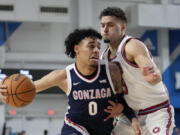 Gonzaga guard Julian Strawther (0) controls the ball against Loyola Marymount forward Alex Merkviladze (23) during the first half of an NCAA college basketball game in Los Angeles, Thursday, Feb. 16, 2023.