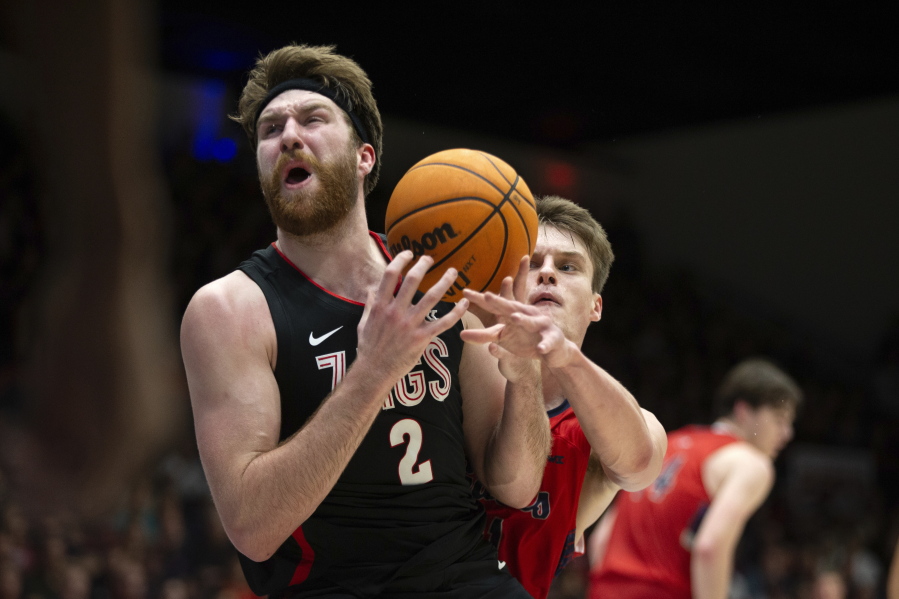 Gonzaga forward Drew Timme (2) is fouled by Saint Mary's center Mitchell Saxen (11) as he drive the lane during the first half of an NCAA college basketball game, Saturday, Feb. 4, 2023, in Moraga, Calif. (AP Photo/D.