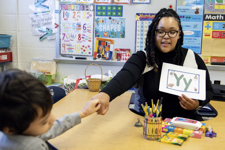 Student teacher Lana Scott teaches the alphabet to a small group of kinder-gartners Jan. 24 at Whitehall Elementary School in Bowie, Md.