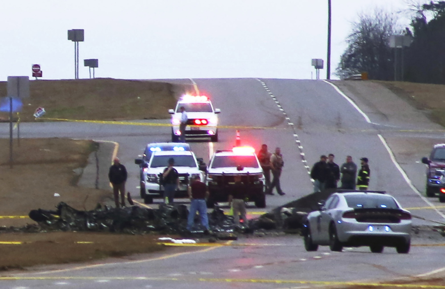 Law enforcement work at the scene of a Black Hawk helicopter crash Wednesday, Feb. 15, 2023, in the unincorporated community of Harvest, Ala. U.S. military officials say two people on board the helicopter, which was from the Tennessee National Guard, were killed.