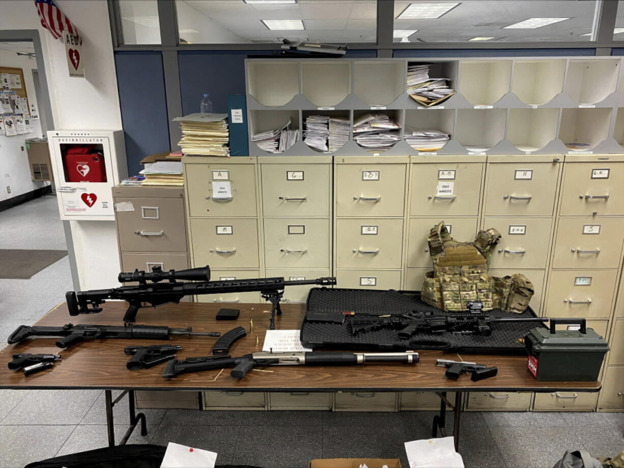 This photo provided by the Los Angeles Police Department shows guns and ammunition that were found in an L.A. apartment. A man who reportedly made violent threats was arrested and investigators found a cache of guns and ammunition in his Hollywood high-rise apartment, where several rifles were pointed at a nearby park, police said Wednesday, Feb. 1, 2023.