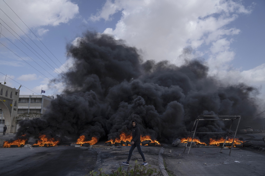 Palestinian protesters block the main road with burning tires in the West Bank city of Jericho, Monday, Feb. 6, 2023.