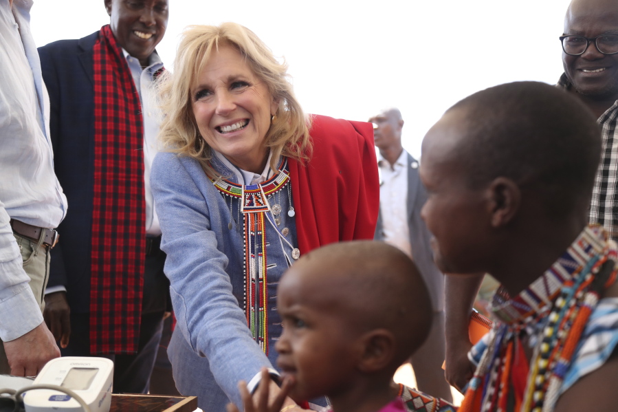 US first Lady Jill Biden, left, greets women of the Maasai community as they explain the drought situation in Ngatataek, Kajiado Central, Kenya, Sunday, Feb. 26, 2023. Biden is in Kenya on the second and final stop of her trip.